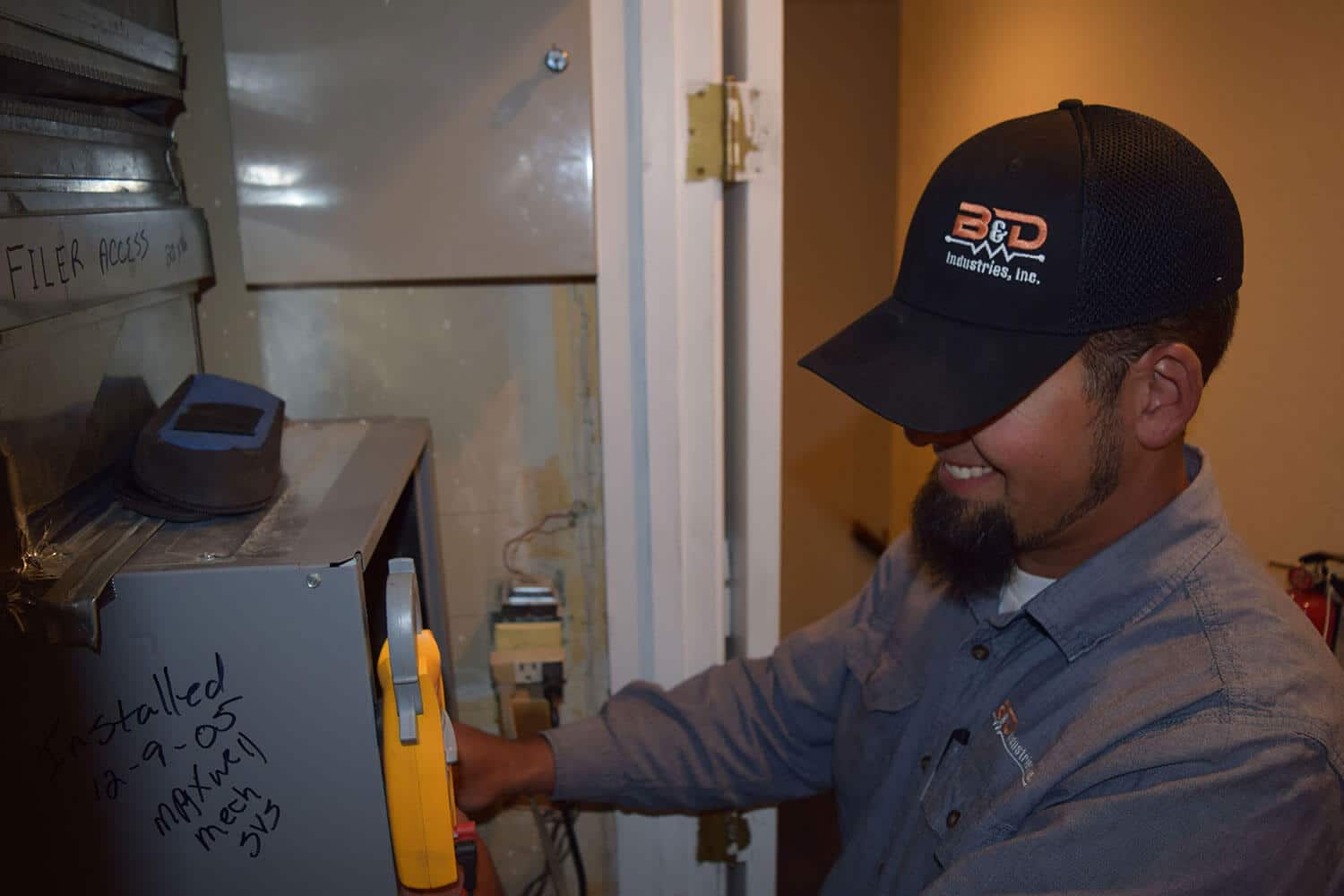 B&D electrical repair technician checking a home circuit breaker