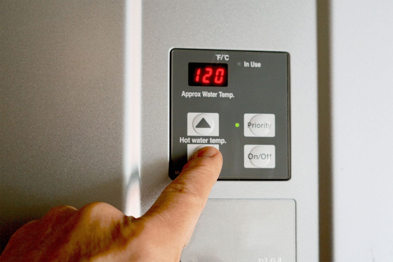 Finger on Water Heater Controls